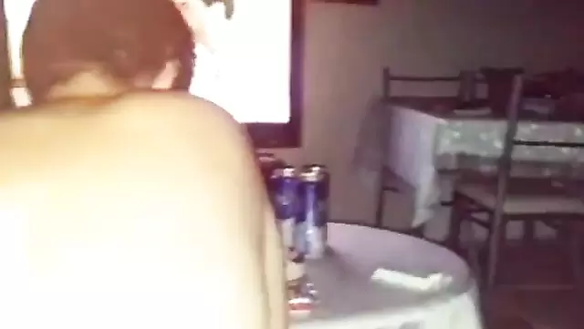 A plump Turkish woman gives a blowjob to her husband in front of the TV